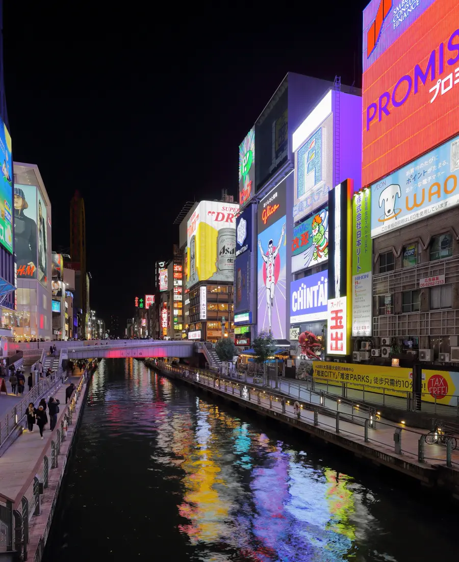 A wall of illuminated signs along the Dōtonbori canal in Osaka