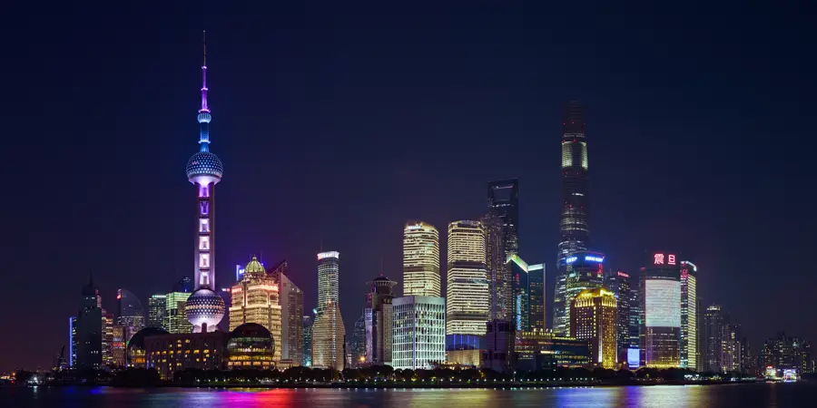 The illuminated Pudong skyline in Shanghai at night with the Oriental Pearl Tower